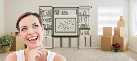 Woman Inside Room With Moving Boxes Glancing Toward Entertainment Unit Drawing on Wall photo