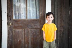 Mixed Race Chinese and Caucasian Boy Standing Alone on Porch photo