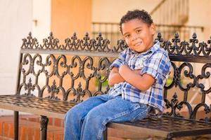 Handsome African American and Mexican Boy Sitting on Park Bench photo