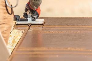 Construction Worker Using Hand Groover On Wet Cement Forming Coping Around New Pool photo