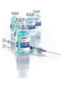 Coronavirus COVID-19 Vaccine Vials and Syringe On Reflective Surface photo