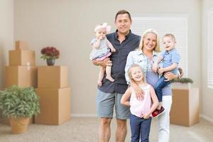 Caucasian Family In Empty Room with Moving Boxes photo