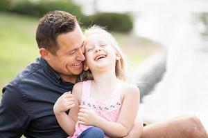 Young Caucasian Father and Daughter Having Fun At The Park photo