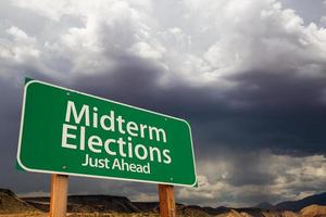 Midterm Elections Green Road Sign Over Dramatic Clouds and Sky. photo