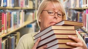 Beautiful Expressive Student or Teacher with Books in Library. photo