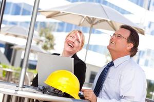 Businesswoman and Man Laughing While Working photo