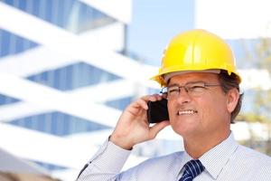 Contractor in Hardhat and Necktie Talks on His Cell Phone photo