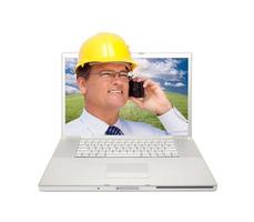 Laptop and Man with Hard Hat on Cell Phone photo