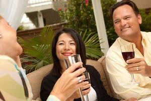 Three Friends Enjoying Wine on the Patio photo