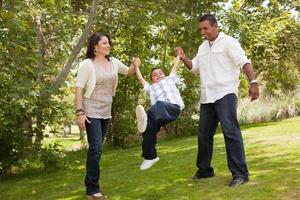 Young Hispanic Family Having Fun in the Park photo