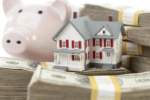 Small House and Piggy Bank with Stacks Money photo