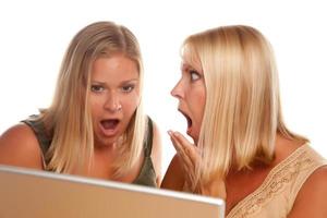 Two Shocked Women Using Laptop photo