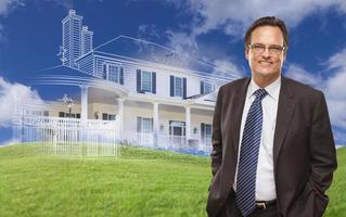 Smiling Businessman with Ghosted House Drawing Behind photo