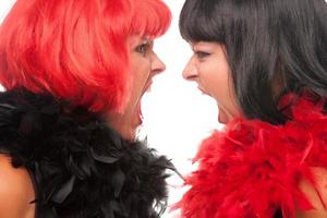 Red and Black Haired Women Screaming at Each Other photo
