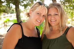 Two Beautiful Smiling Sisters Ourdoor Portrait photo