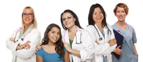Hispanic Female Doctor with Child Patient and Colleagues Behind photo