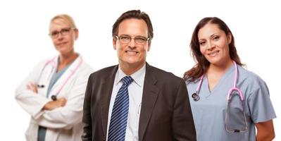 Smiling Businessman with Female Doctor and Nurse photo