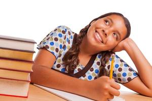 Pretty Hispanic Girl Daydreaming While Studying on White photo