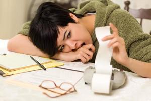 Multi-ethnic Young Woman Agonizing Over Financial Calculations photo