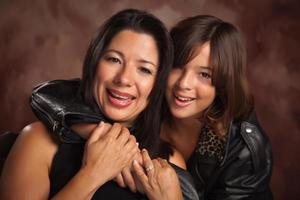 Attractive Hispanic Mother and Daughter Portrait photo