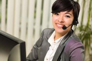 Attractive Young Woman Smiles Wearing Headset photo