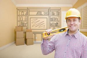 Male Construction Worker In Room With Drawing of Entertainment Unit photo