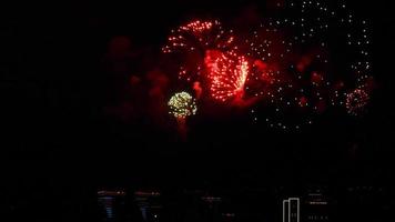 Colorful fireworks in the festive event in the night sky in the city. New Year's and Christmas video