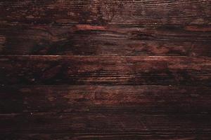 textura de fondo de madera marrón vintage con nudos y agujeros de clavos. antigua pared de madera pintada. fondo abstracto marrón. tableros horizontales oscuros de madera vintage. foto