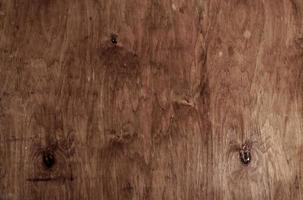 Vintage brown wood background texture with knots and nail holes. Old painted wood wall. Brown abstract background. Vintage wooden dark horizontal boards. photo