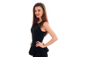 cheerful young lady with red lips in black dress looking at the camera and smiling isolated on white background photo