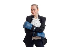 Beautiful blonde business woman in classic unifrom with blue boxing gloves smiling on camera photo