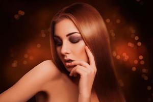 Attractive sensual brown hair woman with closed eyes in studio photo