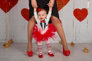 Mother teaching daughter how to walk photo