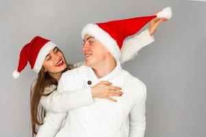 couple in love celebrates christmas in santa hat photo