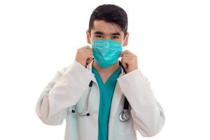 close up portrait of male doctor in uniform posing isolated on white background photo