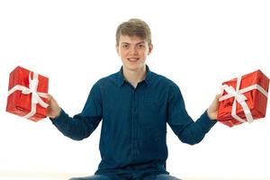 young man with two red gifts in his hands photo