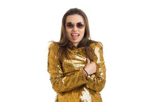 funny young woman in sunglasses and golden jacket screaming on camera photo