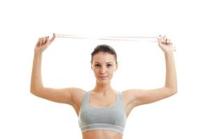 horizontal portrait of a young girl's sports which keeps the head over the measuring tape photo