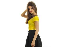 Sexy young woman in yellow and black clothes looking at the camera photo