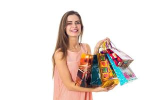 beautiful girl keeps many packages in hand and smiling isolated on white background photo