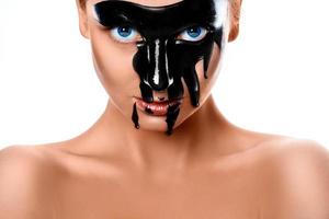 Close up photo of sexy woman with black paint on face