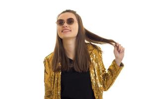 young elegant woman in golden jacket and sunglasses smiling photo