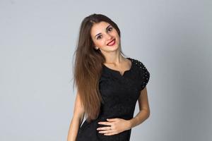 girl in black dress posing in studio photo