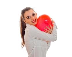 young smiling girl holding a large balloon in the shape of a heart photo