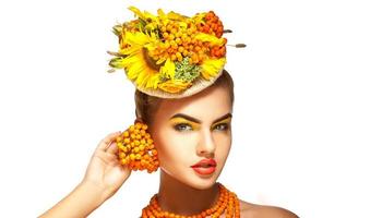 Cute young fashion model with rowanberry on head photo