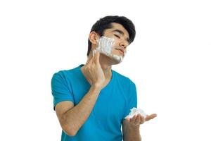 guy putting a face before shaving foam photo