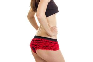 horizontal portrait slim girl in red shorts and a black top photo