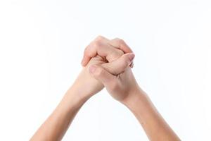 two female hands crossed among themselves isolated on white background photo