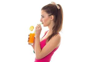 profaile summer portrait of beautiful brunette woman in pink shirt drinks orange cocktail isolated on white background photo