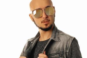 horizontal portrait of Handsome young unshaved man in sunglasses looking away photo